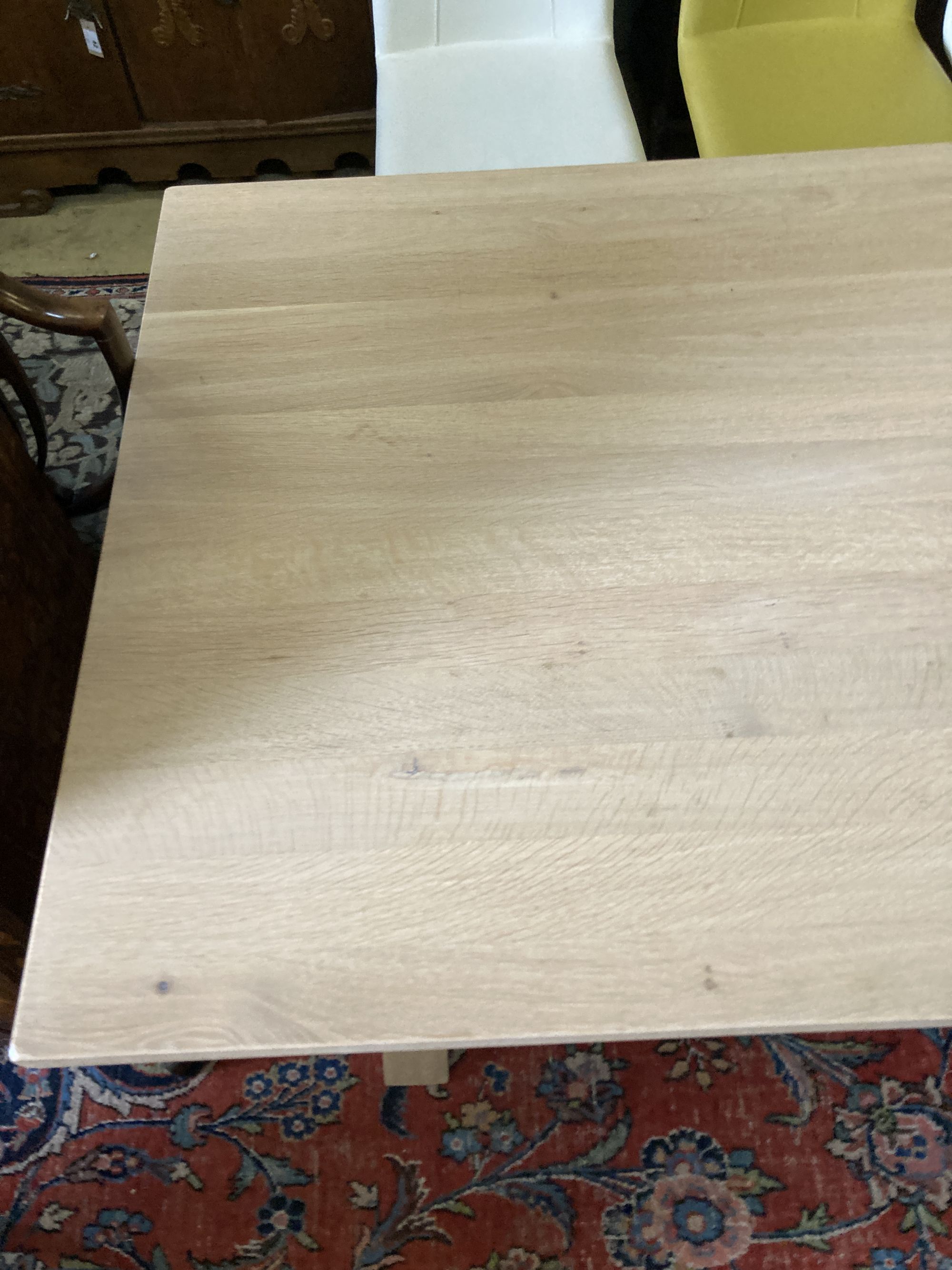 A contemporary oak X-framed dining table, length 200cm, depth 100cm, height 76cm